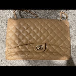 Large tan faux leather quilted bag.